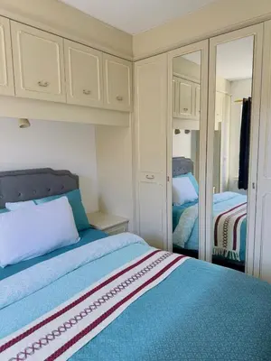 a bedroom with a bed and a mirror at Charming 2br Maisonette In Carlisle Center in Carlisle