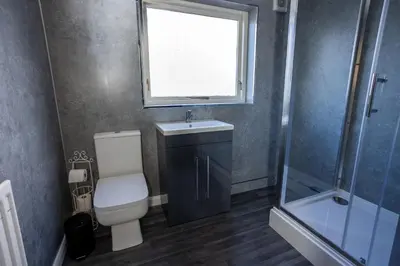 a bathroom with a toilet and a sink and a window at Charming 2br Maisonette In Carlisle Center in Carlisle