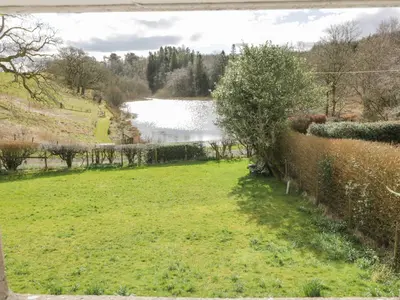 a view from the garden of the lake at Morton Mains Steading Cottage in Thornhill