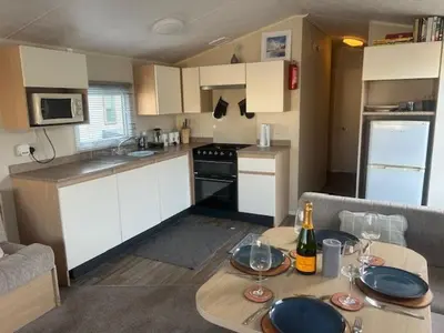 a kitchen with a table with plates on it at Seabreeze Retreat in Port Carlisle
