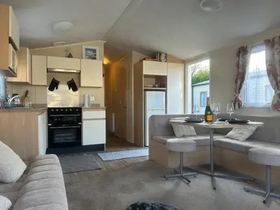 a kitchen and living room with a couch and a table at Seabreeze Retreat in Port Carlisle