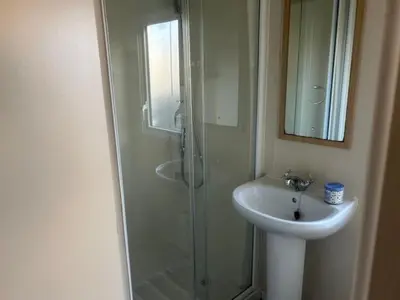 a bathroom with a glass shower and a sink at Seabreeze Retreat in Port Carlisle