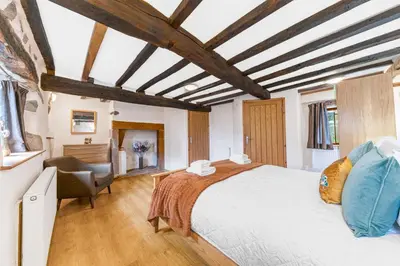 a bedroom with a large bed and a desk at 3 Bed in Waberthwaite oc-d31079 in Waberthwaite