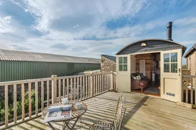 a patio with a table and chairs on a deck at 1 Bed in Uldale oc-m31080 in Uldale