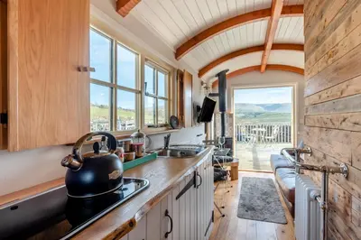 a kitchen with a stove and a sink and a window at 1 Bed in Uldale oc-m31080 in Uldale