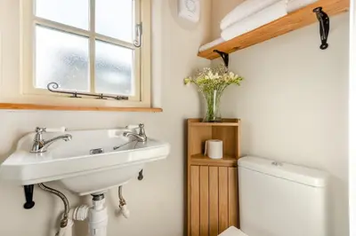 a bathroom with a sink and a toilet and a window at 1 Bed in Uldale oc-m31080 in Uldale