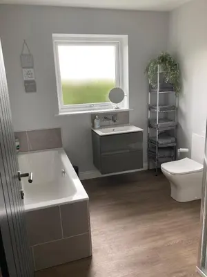a bathroom with a sink and a toilet and a window at Orchard Cottage At Gretna in Gretna