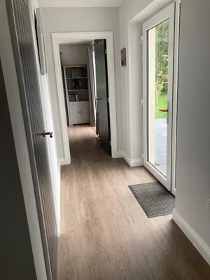 an empty hallway with a door to a room at Orchard Cottage At Gretna in Gretna