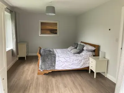 a bedroom with a bed and a nightstand and a bed sidx sidx sidx sidx at Orchard Cottage At Gretna in Gretna