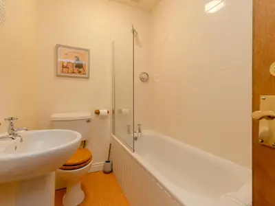 a bathroom with a sink and a toilet and a shower at Holiday Home Doonans Cottage by Interhome in Straiton