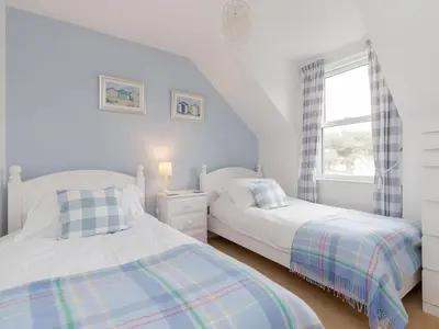 a bedroom with two beds and a window at Holiday Home The Knowe by Interhome in Portpatrick