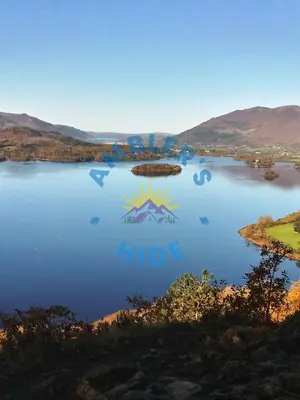 a view of a lake with mountains in the background at Amblers Hide, Brigham, Cockermouth, Cumbria in Cockermouth