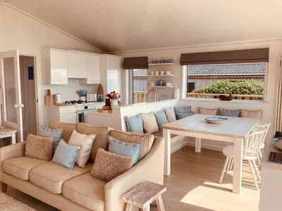 a living room with a couch and a table at The Moorings in Girthon