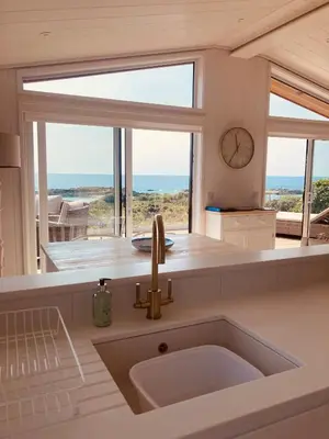 a kitchen with a sink and a large window at The Moorings in Girthon