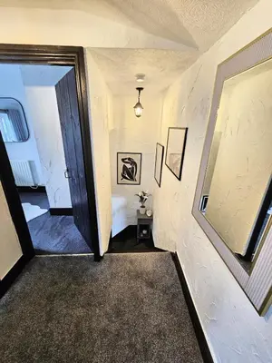 a hallway with a door leading to a room at Leaf Tree Cottage, close to Coast, Lakes and Fells in Workington