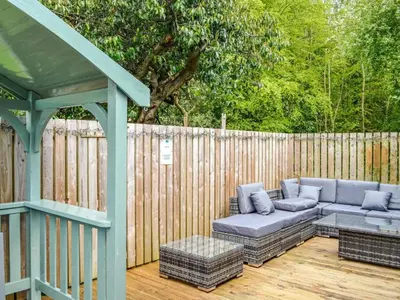 a patio with a couch and a gazebo at Rustic Secluded Hidden Gem At Rockhall in Dumfries