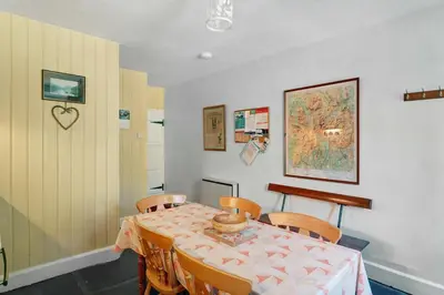 a dining room with a table and chairs at Heron View Cottage in Grasmere