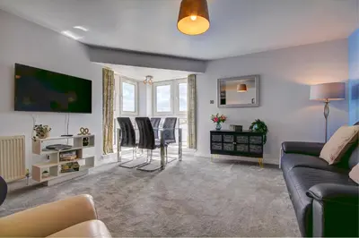 a living room with a couch and a table at River Ayr View-Coorie Doon Stays in Ayr