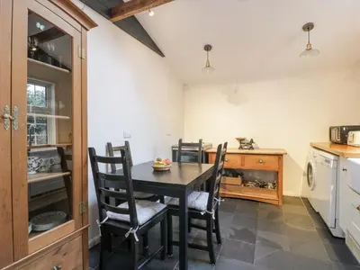 a kitchen with a dining room table and chairs at Hildawn in Dumfries