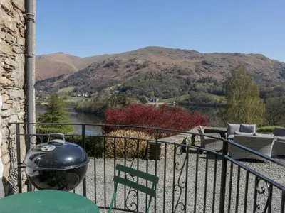 a pot on a balcony with a view of a mountain at Huntingstile South in Ambleside