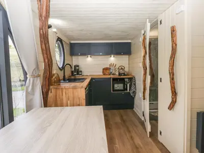 a kitchen with a table in a tiny house at Longlands Lodge in Wigton