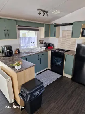 a kitchen with a sink and a stove at Forest Valley Holiday Home in Ballantrae