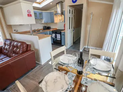 a dining room and kitchen with a table and chairs at New Horizon in Carlisle