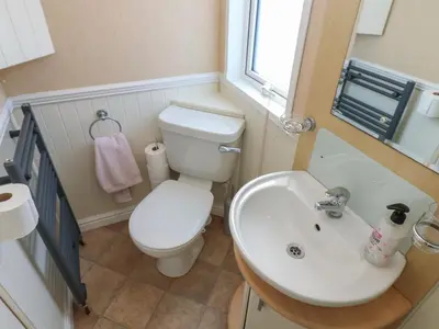 a small bathroom with a toilet and a sink at New Horizon in Carlisle