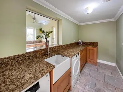 a kitchen with a sink and a mirror at Violet Bank in Cockermouth