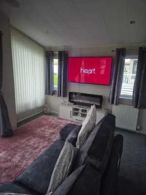 a living room with a couch and a flat screen tv at 2 bedroom platinum in Minishant