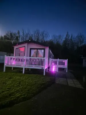 a pink house with a porch with lights on it at 2 bedroom platinum in Minishant