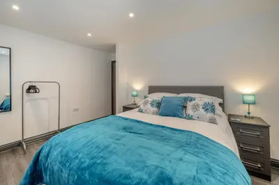 a bedroom with a large bed and two lamps at 3 Bed in Cockermouth oc-o31515 in Embleton