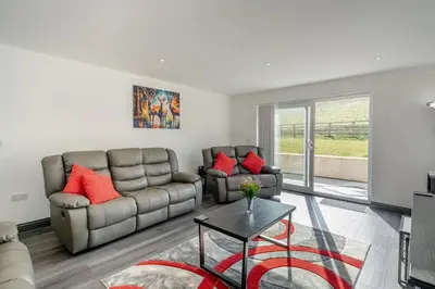 a living room with two couches and a table at 3 Bed in Cockermouth oc-o31515 in Embleton