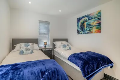 a bedroom with two beds and a painting on the wall at 3 Bed in Cockermouth oc-o31515 in Embleton
