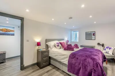 a bedroom with a purple blanket on a bed at 1 Bed in Cockermouth oc-s31514 in Embleton