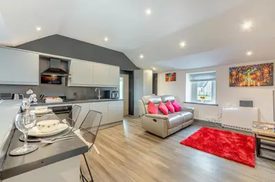 a kitchen and living room with a couch and a table at 1 Bed in Cockermouth oc-s31514 in Embleton