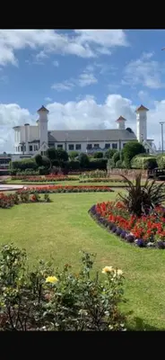 a garden with flowers in front of a building at Saltayr in Ayr