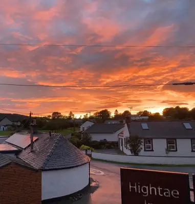 a sunset in a small town with houses at Hightae B&B in Hightae