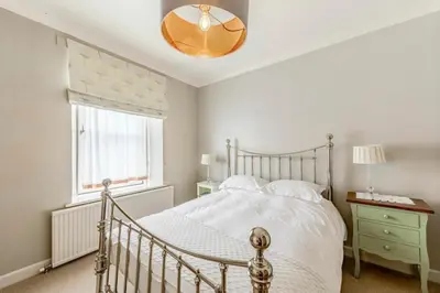 a bedroom with a white bed and a window at Hightae B&B in Hightae
