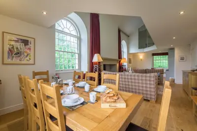 a dining room with a wooden table and chairs at The School at Mungrisdale in Penrith