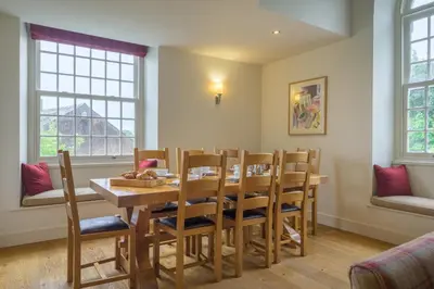 a dining room with a wooden table and chairs at The School at Mungrisdale in Penrith