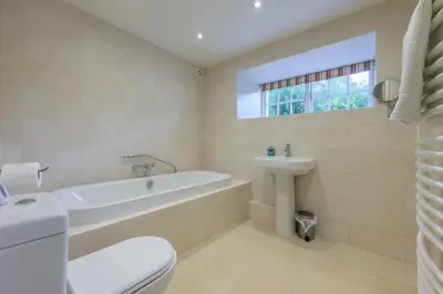 a bathroom with a tub and a sink and a toilet at The School at Mungrisdale in Penrith