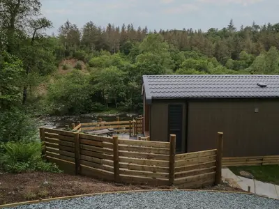 a wooden fence in front of a building at Dubs Luxury Family Pod in Keswick