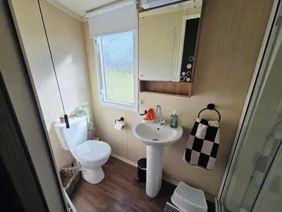 a small bathroom with a toilet and a sink at The Canny View at Three Lochs Holiday Park in Balminnoch 3 bedroom sleeps upto 8 guests in Newton Stewart