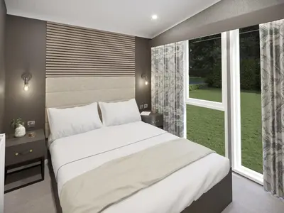 a bedroom with a large white bed and a window at Hodge Luxury Pod in Keswick