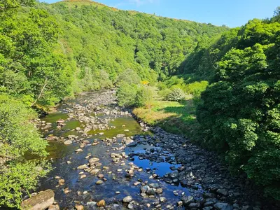 an aerial view of a river with rocks and trees at Elter Luxury Pod in Keswick