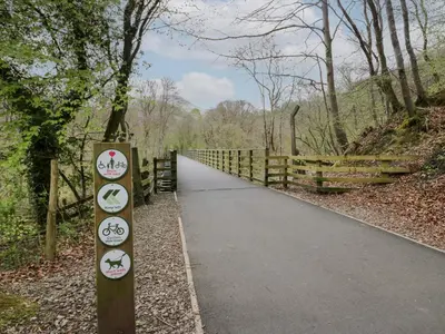 a path in the woods with signs on it at Elter Luxury Pod in Keswick