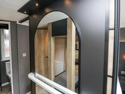 a large mirror in a room with a room at Woof Luxury Family Pod in Keswick
