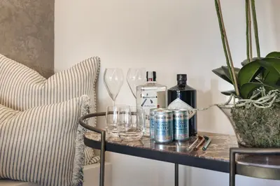 a table with glasses and a bottle of wine at The Sanctuary - Ridgestone in Watermillock