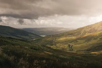 a view of a valley with a road in the mountains at The Sanctuary - Ridgestone in Watermillock